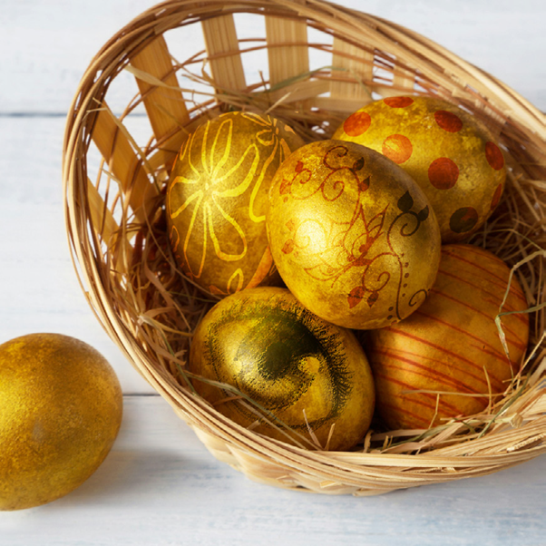 A basket of eggs painted with metallic designs.