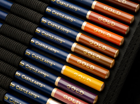 Close up of Castle Gold coloured pencils in a soft zip case.”>